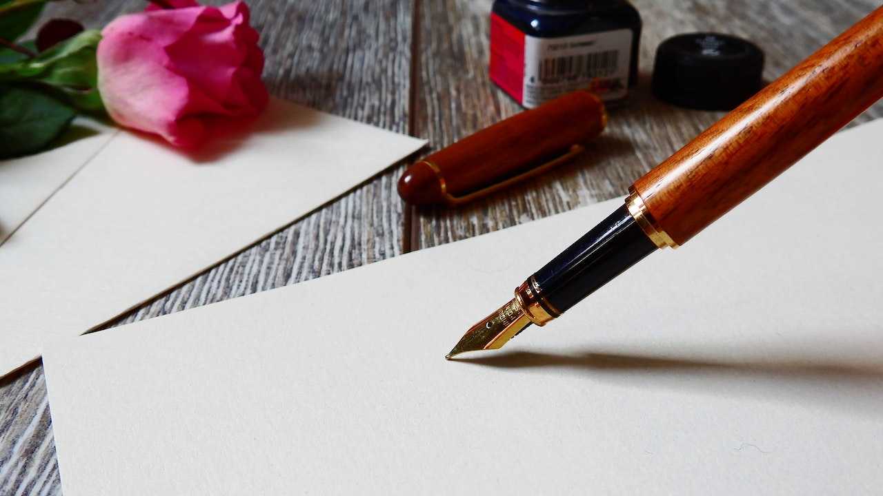 A fountain pen on white paper.